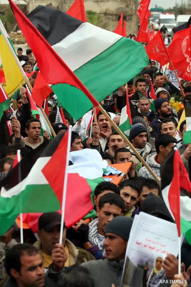 Palestinian carry the body of Jawaher Abu Rahmah during her funeral at the her West Bank Village of Bil'in, on 01 January 2011. Jawaher, 36, who was protesting against Israel's West Bank separation barrier, was evacuated...