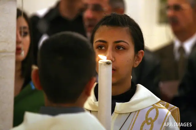Palestinian Christians attend a special mass held at the Holy Family Church in the Palestinian West Bank city of Ramallah on January 2, 2011 to commemorate the victims of the New Year bomb attack against a Coptic church...