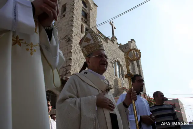 The Latin Patriarch of Jerusalem Fuad Twal leads a special mass held at the Holy Family Church in the Palestinian West Bank city of Ramallah on January 2, 2011 to commemorate the victims of the New Year bomb attack again...