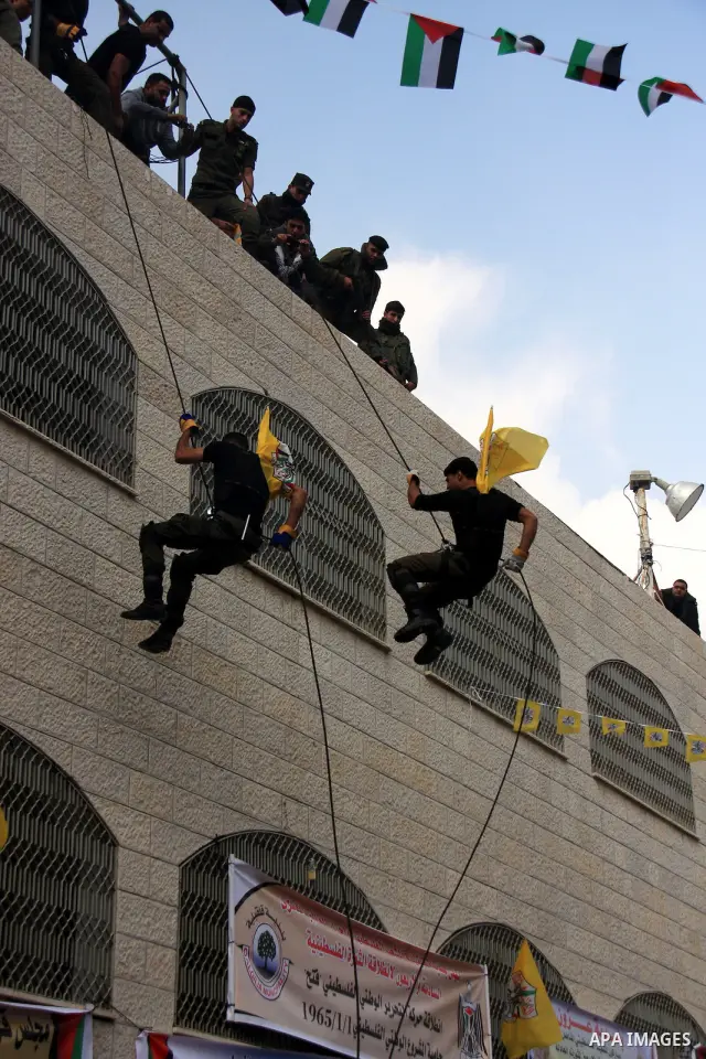 Palestinian supporters from the Fatah movement participate in a rally marking the 46th anniversary since the group's foundation in the West Bank city of Qalqilya, Tuesday, Jan. 4, 2011. Photo by Wagdi Eshtayah