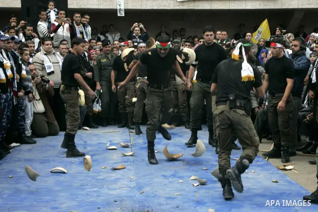 Palestinian supporters from the Fatah movement participate in a rally marking the 46th anniversary since the group's foundation in the West Bank city of Qalqilya, Tuesday, Jan. 4, 2011. Photo by Wagdi Eshtayah
