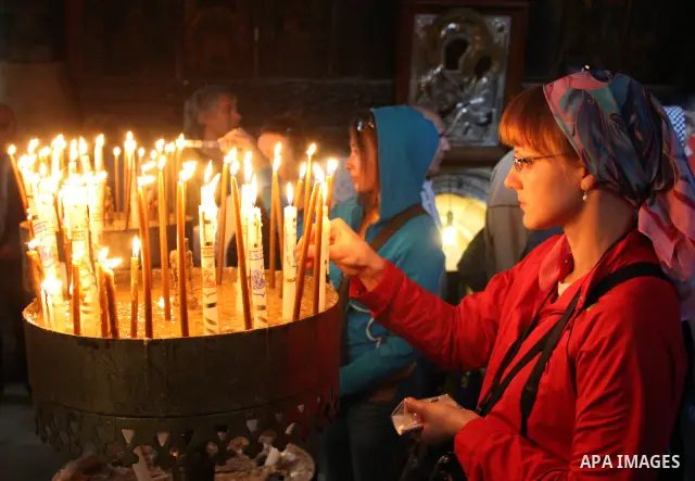 A worshipper lights a candle in the Church of the Nativity, traditionally accepted as the birthplace of Jesus Christ, in the West Bank city of Bethlehem on January 05, 2011. Photo by Najeh Hashlamoun