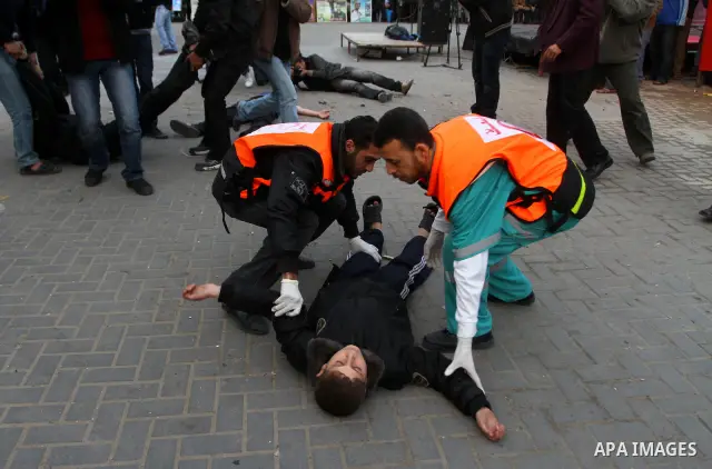 Palestinian youths act as mock injured as they take part in a rally organised by Hamas marking the second anniversary of the Israel-Gaza war in the Jabalia refugee camp in the northern Gaza Strip on January 6, 2011. Phot...
