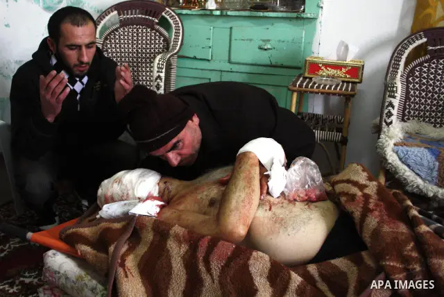 Family members gather around the body of a 67-year-old Palestinian man shot dead by Israeli troops and identified as Omar Kawasme after his transfer to the mortuary of a hospital in Hebron on January 7, 2010. The Palesti...