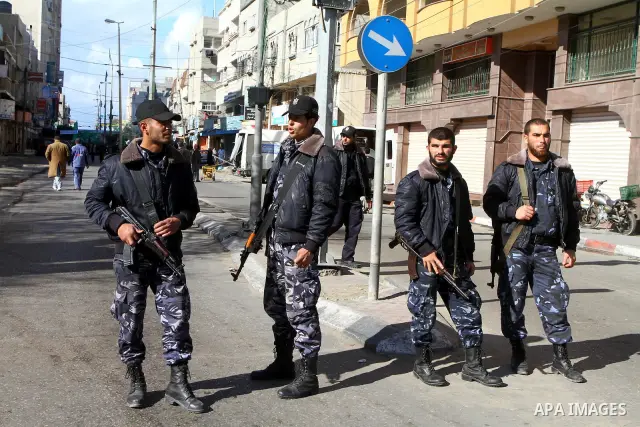 Palestinian security forces stand guard during a rally organized by Hamas movement in Gaza city against Mahmud Abbas Authority on Jan. 7,2011. A Palestinian man was shot dead by Israeli soldiers during a raid in the West...
