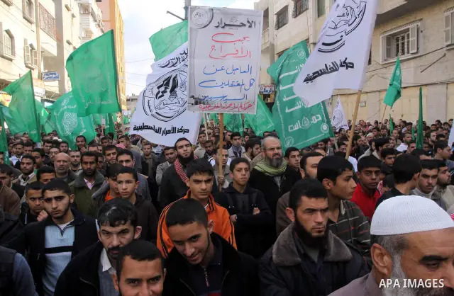 Palestinian Hamas supporters take part in a rally in Gaza city against Mahmud Abbas Authority on Jan. 7,2011. A Palestinian man was shot dead by Israeli soldiers during a raid in the West Bank to arrest suspected militan...