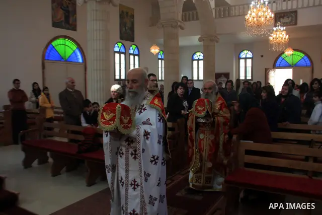Palestinian Greek Orthodox worshipers attend Christmas services at a Greek Orthodox church in the West Bank city of Nablus, Friday, Jan. 7, 2011. Christmas falls on Jan. 7 for Orthodox Christians in Eastern Orthodox chur...