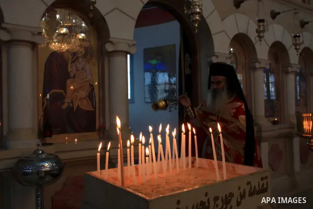 Palestinian Greek Orthodox worshipers attend Christmas services at a Greek Orthodox church in the West Bank city of Nablus, Friday, Jan. 7, 2011. Christmas falls on Jan. 7 for Orthodox Christians in Eastern Orthodox chur...