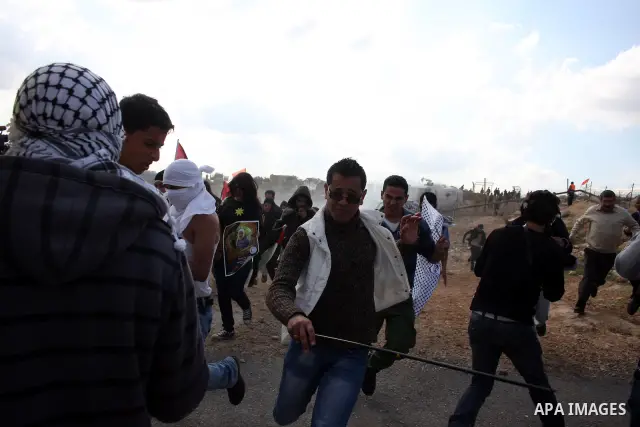 Isareli soldiers disperse protesters in the village of Bilin on January 7, 2011. Israeli troops in Hebron shot dead an elderly Palestinian civilian on Friday in a case of mistaken identity as they searched for a Hamas pr...