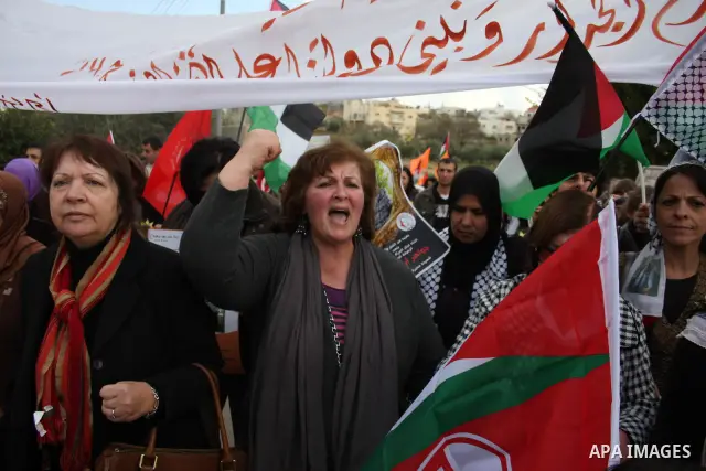 Palestinians take part in a protest in the village of Bilin on January 7, 2011. Israeli troops in Hebron shot dead an elderly Palestinian civilian on Friday in a case of mistaken identity as they searched for a Hamas pri...