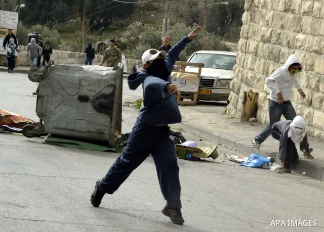 Palestinian youths hurl stones towards Israeli soldiers during clashes with Palestinian youths in the Arab east Jerusalem neighbourhood of Silwan against Jewish settlement activity in the Palestinian districts of the hol...