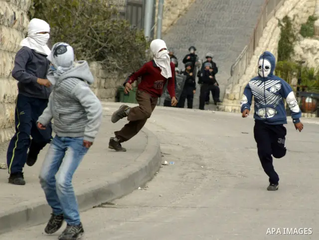 Palestinian youths hurl stones towards Israeli soldiers during clashes with Palestinian youths in the Arab east Jerusalem neighbourhood of Silwan against Jewish settlement activity in the Palestinian districts of the hol...