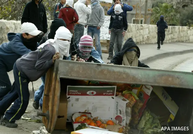 Palestinian youths hurl stones towards Israeli soldiers during clashes with Palestinian youths in the Arab east Jerusalem neighbourhood of Silwan against Jewish settlement activity in the Palestinian districts of the hol...