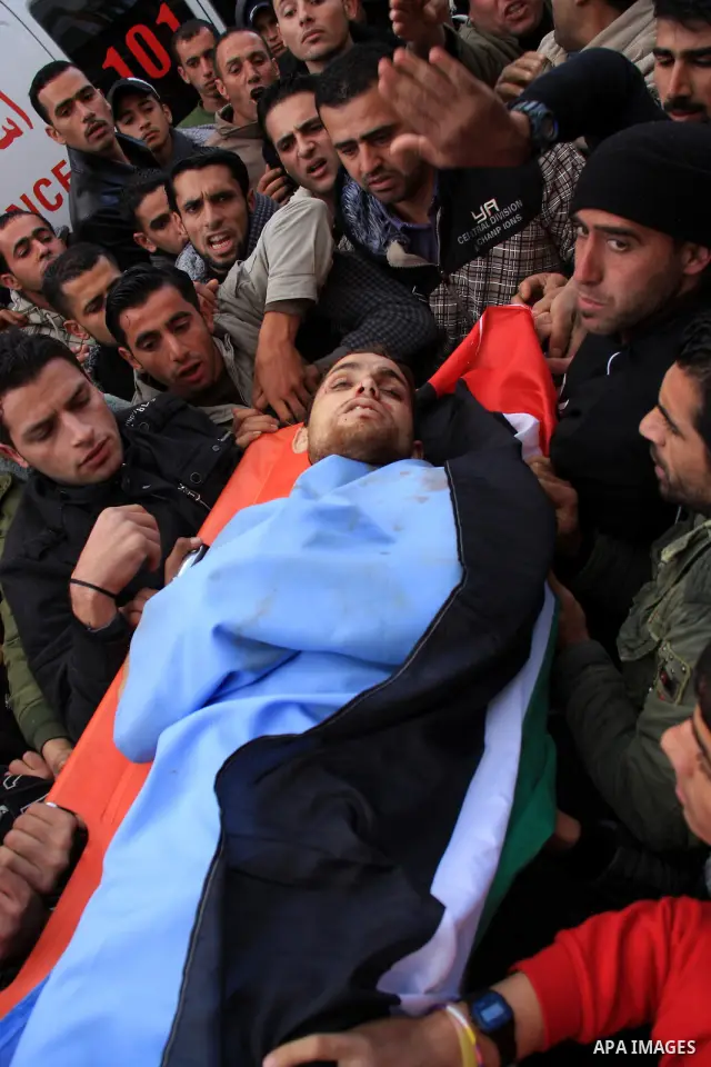Palestinians carry the body of Khaldon Samodi ,25, during his funeral at al Yamoun Village near The West Bank City of Jenin on 08 January 2011. Israeli soldiers allegedly shot and killed Samodi at Hamra checkpoint east o...