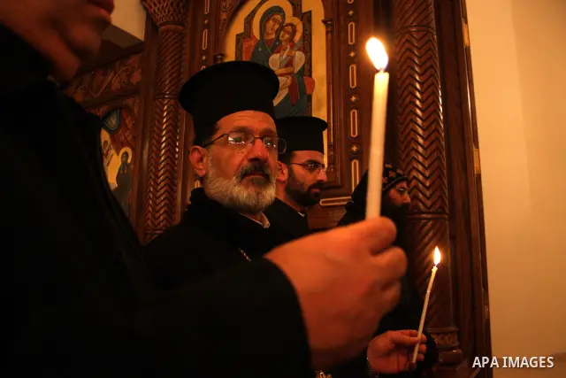 Palestinian Christians light candles at the Copts church in the West Bank city of Ramallah on January 9, 2011 to .A powerful bomb, possibly from a suicide attacker, exploded in front of a Coptic Christian church in Alexa...