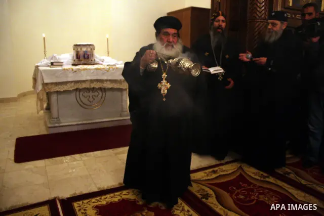 Palestinian Christians light candles at the Copts church in the West Bank city of Ramallah on January 9, 2011 to .A powerful bomb, possibly from a suicide attacker, exploded in front of a Coptic Christian church in Alexa...
