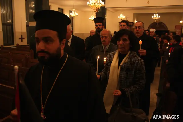 Palestinian Christians light candles at the Copts church in the West Bank city of Ramallah on January 9, 2011 to .A powerful bomb, possibly from a suicide attacker, exploded in front of a Coptic Christian church in Alexa...