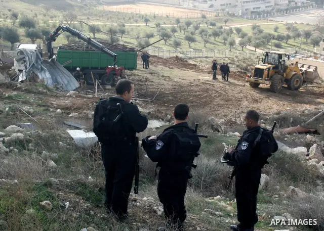 Israeli soldiers take position during a demolishing to horse stable for a Palestinian as Israeli army say that the stable was built without a construction permit, in the Arab Jerusalem neighborhood of Wadi al-Joz, on Jan...