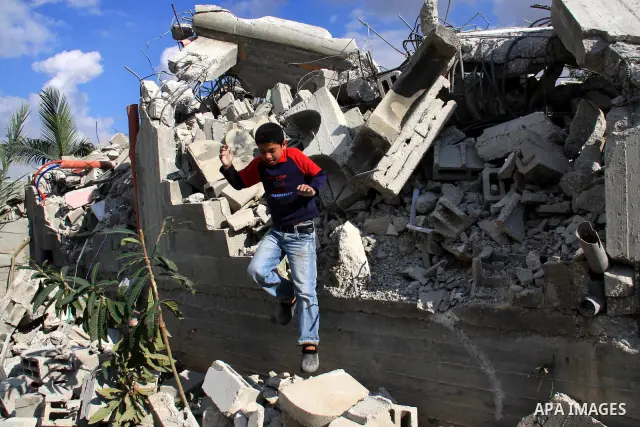 Palestinian Samer Younis family walk on the rubble of her house after Israeli troops demolished the house that was built without a construction permit in the West Bank village of Azzun Atma, near Qalqilia, Tuesday on Jan...