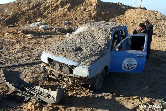 Palestinian Hamas police officers survey the damage after an Israeli air strike on a Hamas security compound in al-Nuseirat refugee camp in the central Gaza Strip January 12, 2011. Security officials said three air strik...