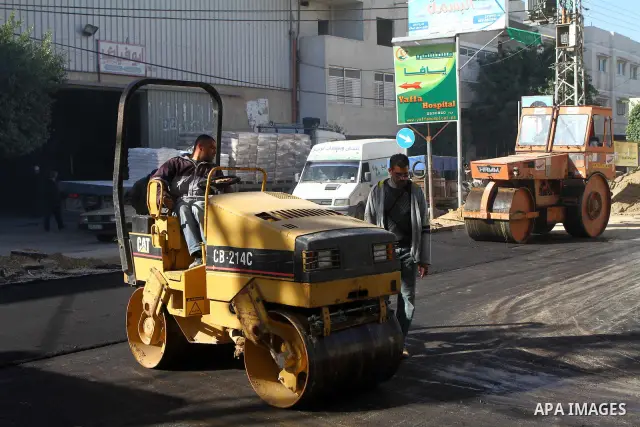 Palestinian workers lay asphalt as a street is paved in Deir El-Balah town central Gaza Strip on Jan. 13, 2011.. Photo by Ashraf Amra