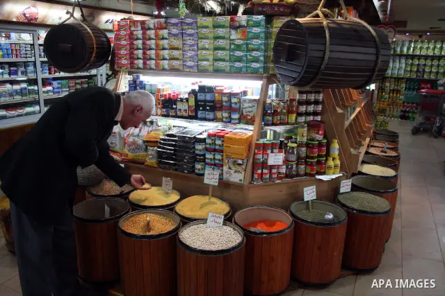 Palestinians display their goods at a food store in the West Bank city of Hebron on January 13, 2011. Photo by Najeh Hashlamoun