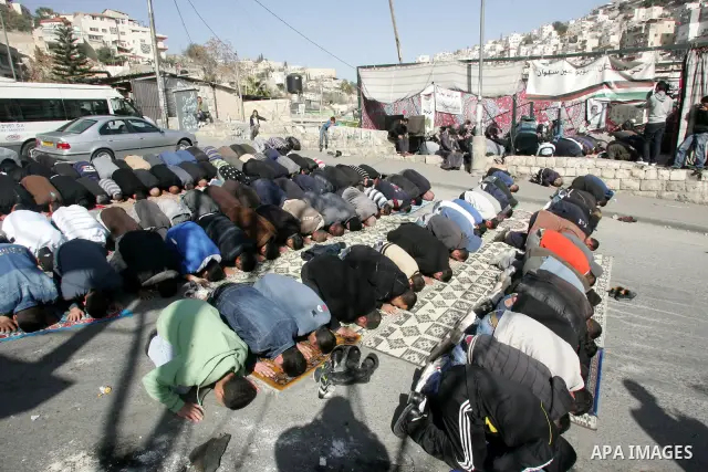 Palestinian Muslim worshipper attend Friday prayers near a protest tent in the mostly Arab neighbourhood of Silwan in east Jerusalem on Jan 14, 2011. Photo by Mahfouz Abu Turk