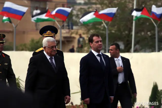 Palestinian President Mahmoud Abbas and Russian President Dmitry Medvedev review an honor guard prior to their meeting in the West Bank town of Jericho, Tuesday, Jan. 18, 2011. Medvedev arrived in the West Bank on Tuesda...