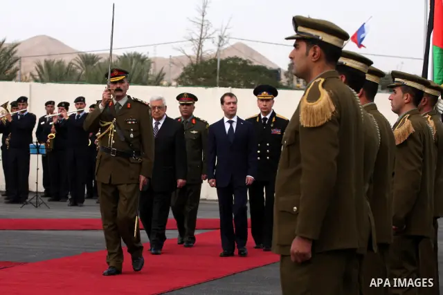 Palestinian President Mahmoud Abbas and Russian President Dmitry Medvedev review an honor guard prior to their meeting in the West Bank town of Jericho, Tuesday, Jan. 18, 2011. Medvedev arrived in the West Bank on Tuesda...