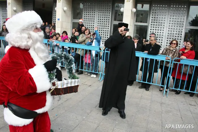 Orthodox Armenian take part in a procession outside the Church of the Nativity in the West Bank town of Bethlehem on Christmas Eve, January 18, 2011. While most Armenians celebrate Christmas on January 6th, the Orthodox...