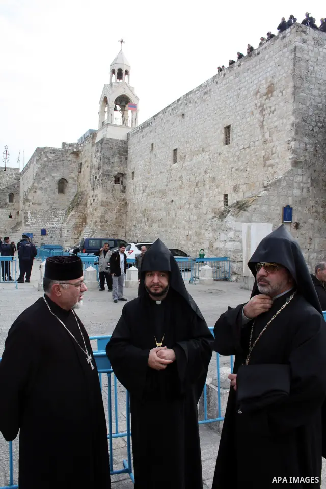Orthodox Armenian take part in a procession outside the Church of the Nativity in the West Bank town of Bethlehem on Christmas Eve, January 18, 2011. While most Armenians celebrate Christmas on January 6th, the Orthodox...