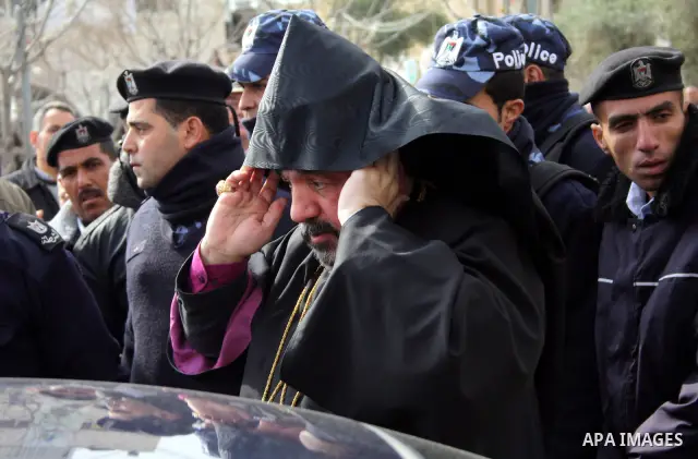 Armenian Orthodox Archbishop Nourhan Manougian across the Manger Square outside the the Church of the Nativity, which houses the biblical birth place of Jesus Christ, in the West Bank town of Bethlehem on January 18, 201...