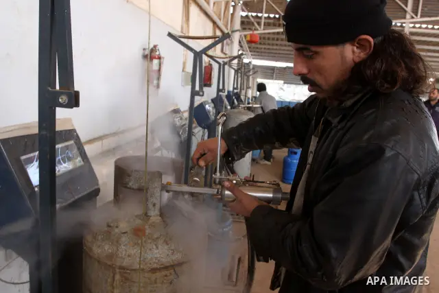 A Palestinian worker fills an empty cylinders at a gas station in Gaza City, Jan. 19, 2011. Local officials said that the consumption of cooking gas mainly in houses, bakeries, hospitals, restaurants and farms during win...