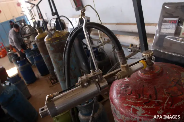 Palestinian workers fill an empty cylinders at a gas station in Gaza City, Jan. 19, 2011. Local officials said that the consumption of cooking gas mainly in houses, bakeries, hospitals, restaurants and farms during winte...