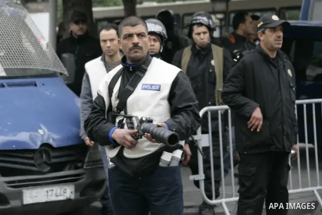 Riot police officers uses tear gas after a demonstration against Constitutional Democratic Rally, RCD, party of Ben Ali in the center of Tunis, Tuesday, Jan. 18. 2011. Four ministers quit Tunisia's day-old government on...