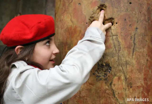 A Palestinian girl prays in the Church of the Nativity, the site revered as the birthplace of Jesus, in the West Bank town of Bethlehem, ahead of the Eastern Orthodox Christmas January 19, 2011. Photo by Najeh Hashlamoun