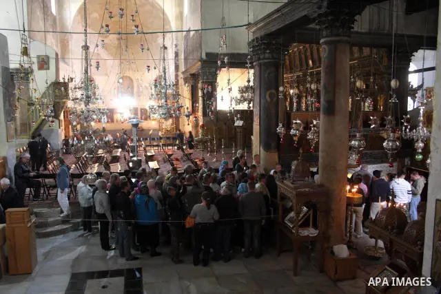 Tourists visit the Church of the Nativity, the site revered as the birthplace of Jesus, in the West Bank town of Bethlehem, ahead of the Eastern Orthodox Christmas January 19, 2011. Photo by Najeh Hashlamoun
