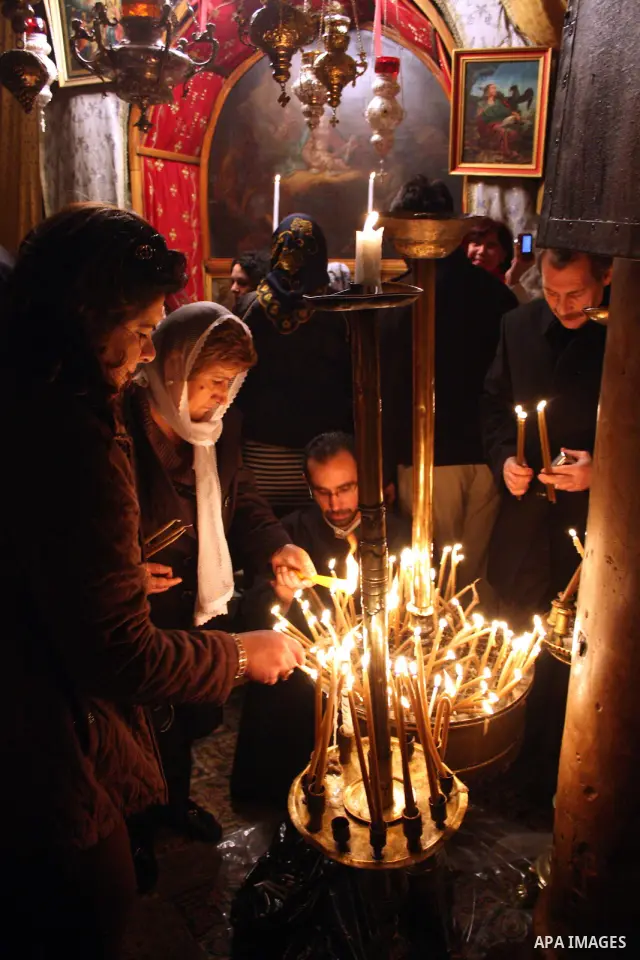 Worshippers light candles in the Church of the Nativity, the site revered as the birthplace of Jesus, in the West Bank town of Bethlehem, ahead of the Eastern Orthodox Christmas January 19, 2011. Photo by Najeh Hashlamou...
