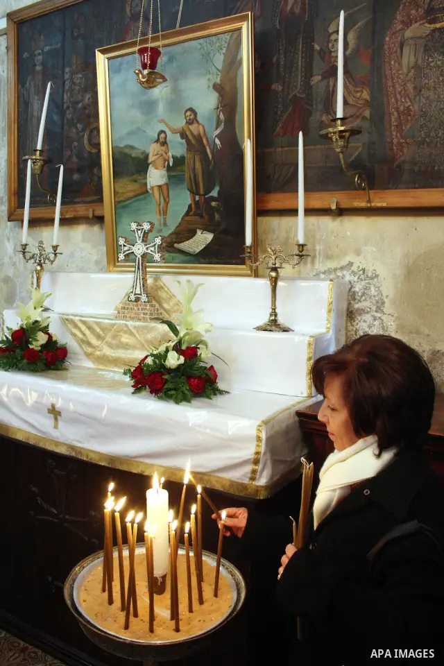 A worshipper lights a candle in the Church of the Nativity, the site revered as the birthplace of Jesus, in the West Bank town of Bethlehem, ahead of the Eastern Orthodox Christmas January 19, 2011. Photo by Najeh Hashla...