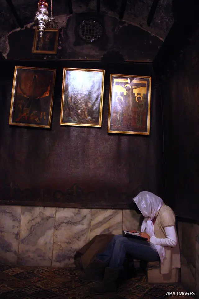 Clergy woman pray in the grotto in the Church of the Nativity, the site revered as the birthplace of Jesus, in the West Bank town of Bethlehem, ahead of the Eastern Orthodox Christmas January 19, 2011. Photo by Najeh Has...
