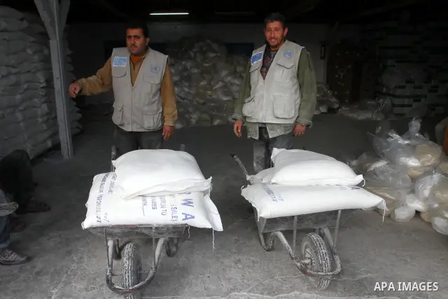 Palestinians receive aid flour sacks from a UN Relief and Works Agency (UNRWA) warehouse in Gaza city, on Jan. 19, 2011. Photo by Ashraf Amra