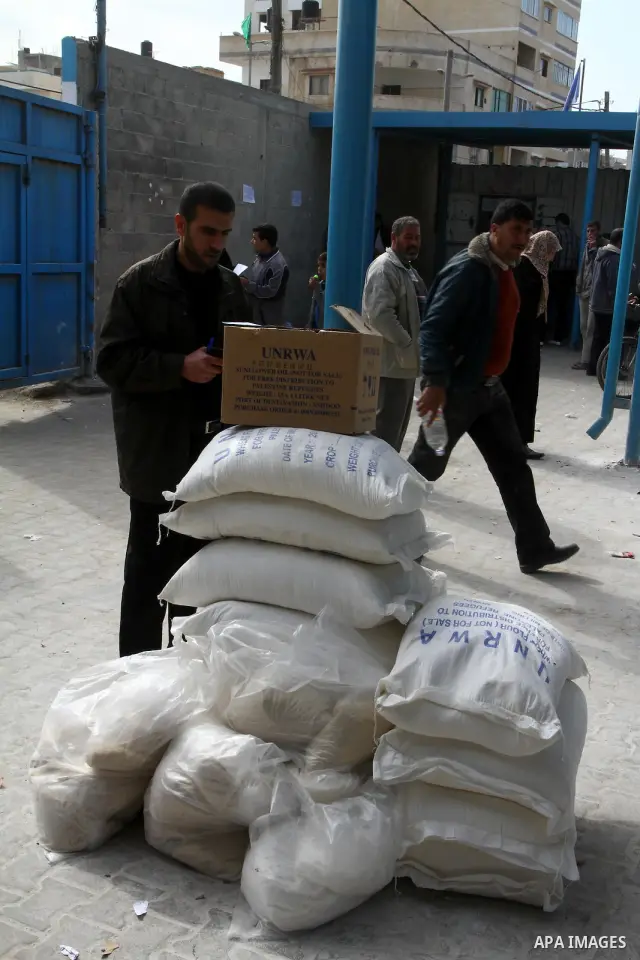 Palestinians receive aid flour sacks from a UN Relief and Works Agency (UNRWA) warehouse in Gaza city, on Jan. 19, 2011. Photo by Ashraf Amra