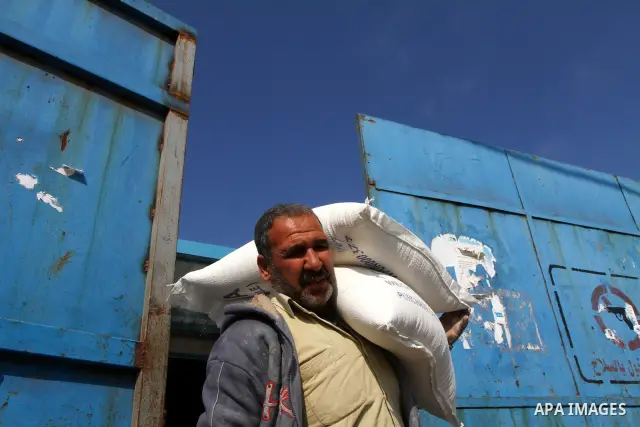 Palestinians receive aid flour sacks from a UN Relief and Works Agency (UNRWA) warehouse in Gaza city, on Jan. 19, 2011. Photo by Ashraf Amra