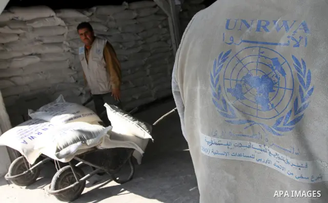 Palestinians receive aid flour sacks from a UN Relief and Works Agency (UNRWA) warehouse in Gaza city, on Jan. 19, 2011. Photo by Ashraf Amra
