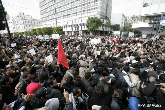 Tunisians take part in a protest calling the former ruling party the Constitutional Democratic Rally (RCD) to withdraw from the newly formed interim government in Tunis, Tunisia, 19 January 2011. Tunisia's transitional g...