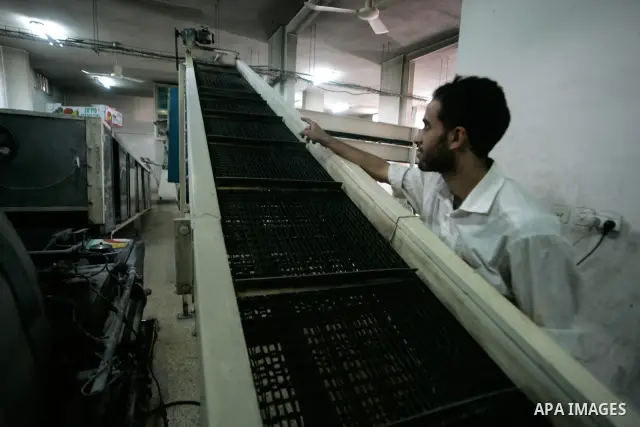 A Palestinian man stands at his stop bakery in the southern Gaza Strip town of Rafah on Jan. 20, 2011. The flour is running out and there will be a crisis within two days because of Israel's refusing to enter the flour t...