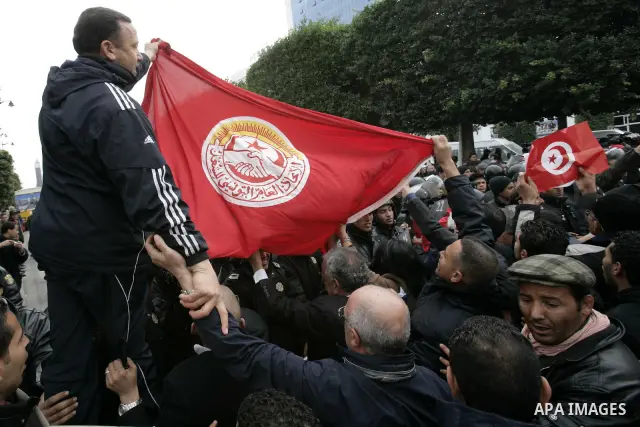 Tunisians take part in a protest in front of the headquarters of the Constitutional Democratic Rally (RCD) party of ousted president Zine al-Abidine Ben Ali during a demonstration in downtown Tunis, January 20, 2011. Tun...
