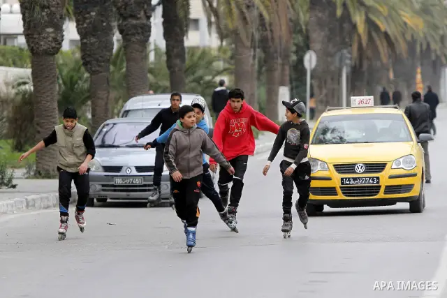Tunisians take part in a protest in front of the headquarters of the Constitutional Democratic Rally (RCD) party of ousted president Zine al-Abidine Ben Ali during a demonstration in downtown Tunis, January 20, 2011. Tun...