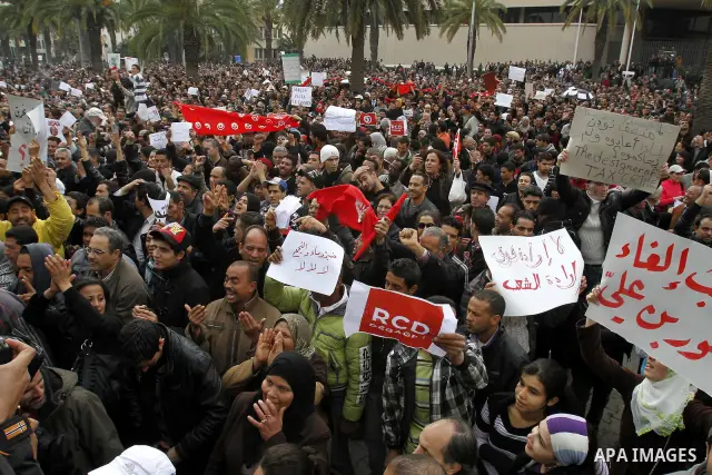 Tunisians take part in a protest in front of the headquarters of the Constitutional Democratic Rally (RCD) party of ousted president Zine al-Abidine Ben Ali during a demonstration in downtown Tunis, January 20, 2011. Tun...
