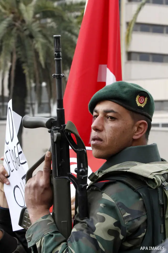 Tunisians take part in a protest in front of the headquarters of the Constitutional Democratic Rally (RCD) party of ousted president Zine al-Abidine Ben Ali during a demonstration in downtown Tunis, January 20, 2011. Tun...